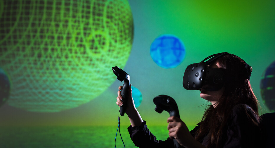 Person wearing a virtual reality headset with a blue and green background